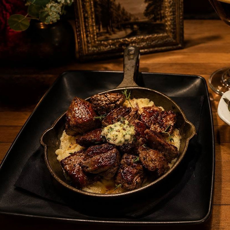 Hibiscus-Coconut-Margarita Tenderloin bites with garlic herb butter served over mashed potatoes